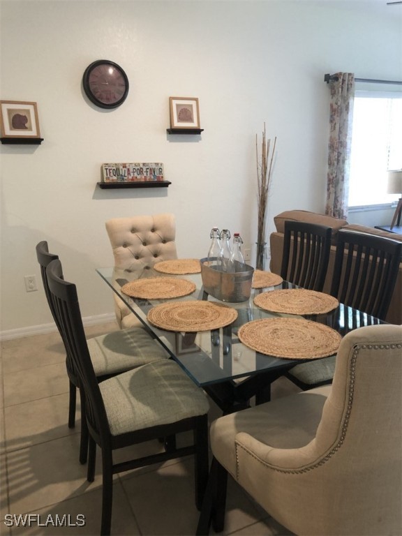 4440 Botanical Pl Circle, Unit 102 Naples, FL 34112 - Photo 3 of 21 a view of a dining room with furniture
