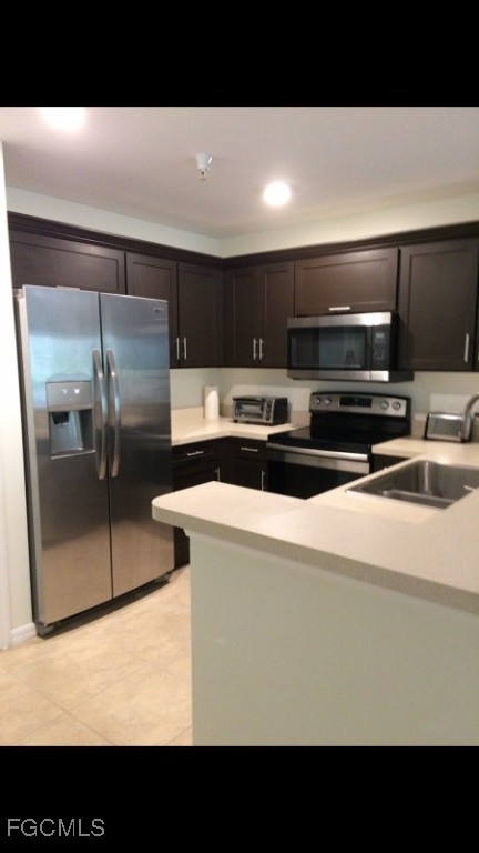 4440 Botanical Pl Circle, Unit 102 Naples, FL 34112 - Photo 6 of 21 a kitchen with a refrigerator a stove and a sink