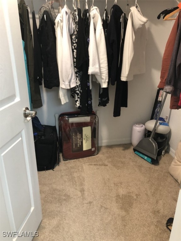 4440 Botanical Pl Circle, Unit 102 Naples, FL 34112 - Photo 10 of 21 wooden floor in ceiling fan and window