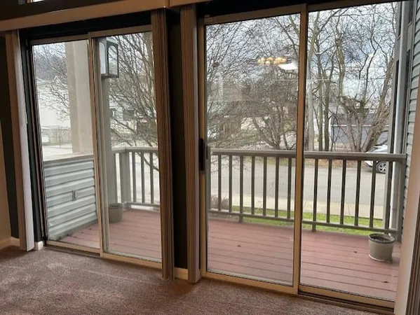 a view of a porch with wooden floor and outside view