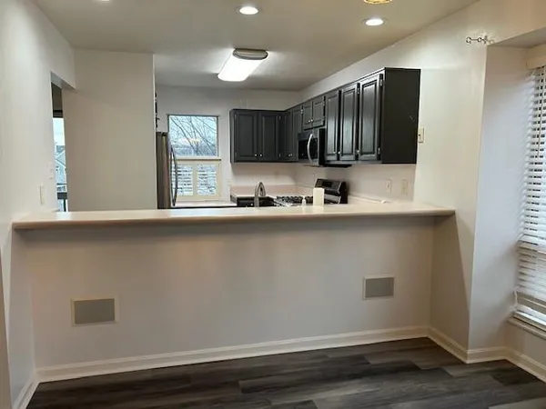 a view of a livingroom with wooden floor and an empty space