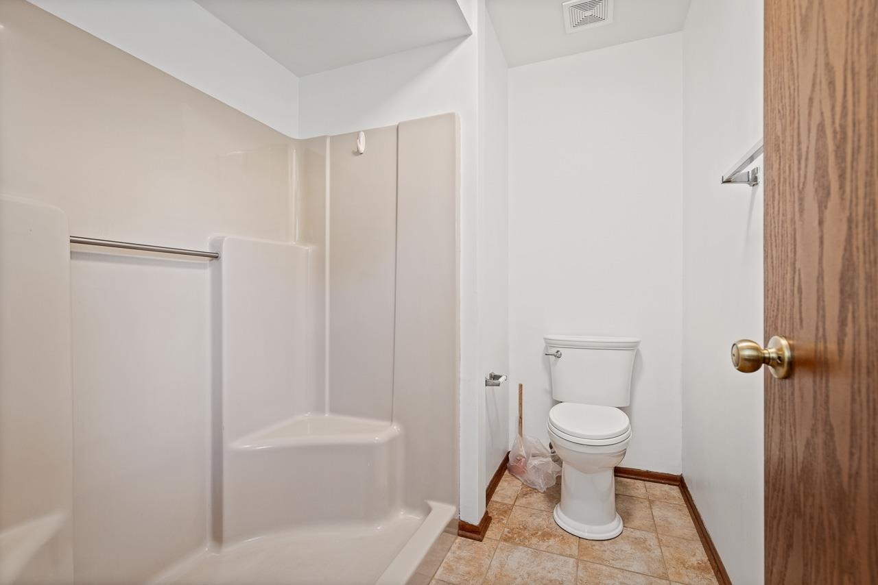3442 North Trainer Road Rockford, IL 61114 - Photo 23 of 35 a bathroom with a toilet and a shower
