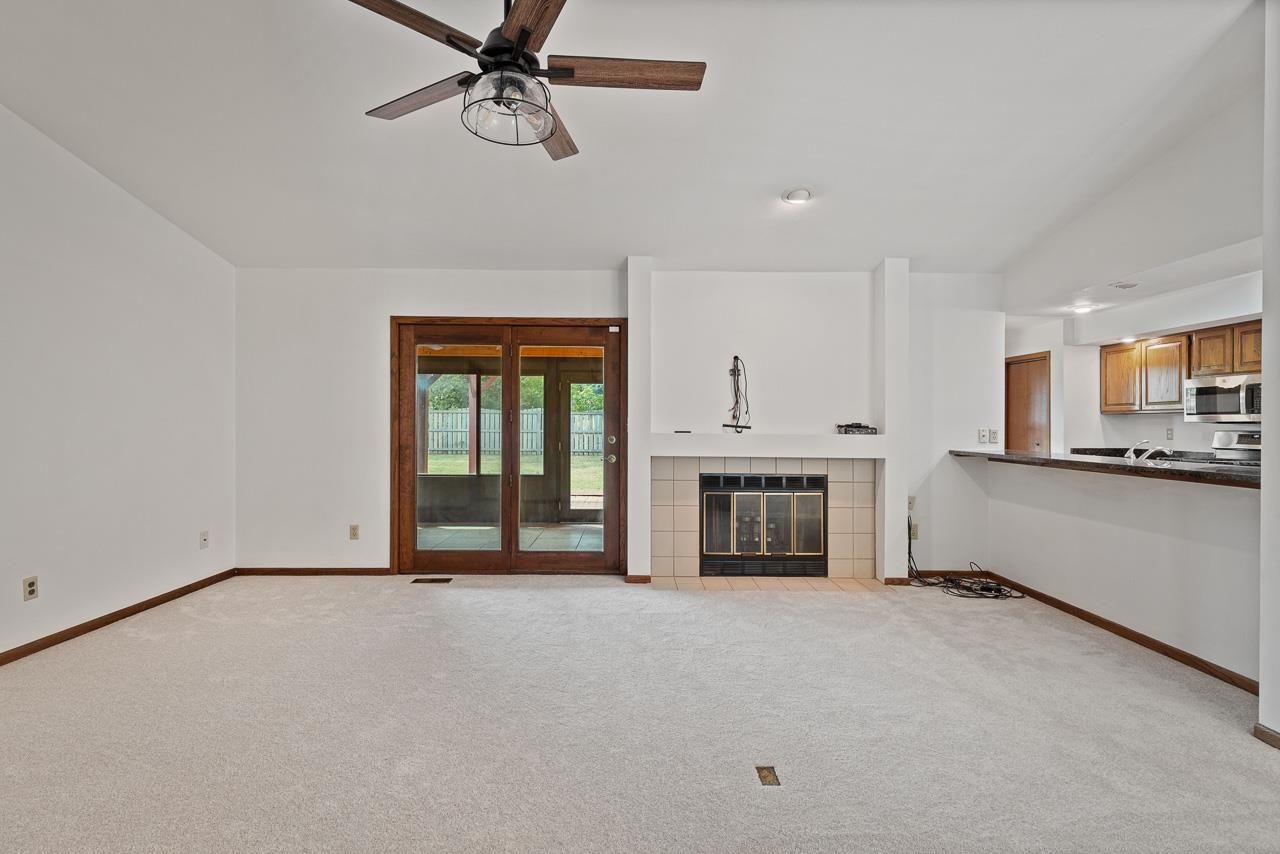 3442 North Trainer Road Rockford, IL 61114 - Photo 4 of 35 a view of an empty room with a fireplace and a window