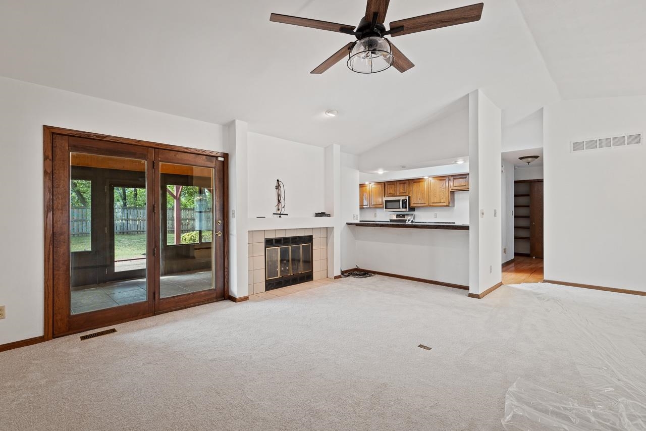 3442 North Trainer Road Rockford, IL 61114 - Photo 7 of 35 a view of a kitchen with an entryway and a fireplace