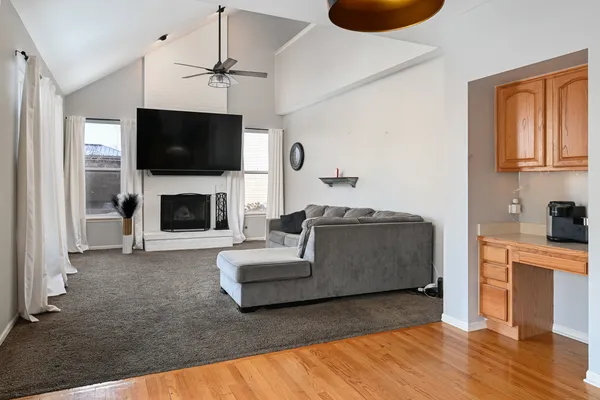 a living room with furniture a flat screen tv and a fireplace