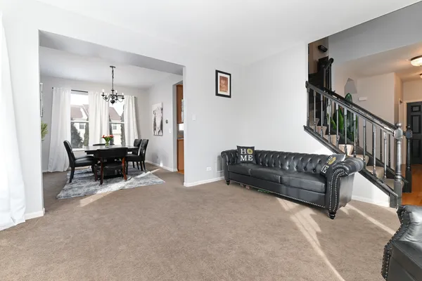 a living room with furniture and a chandelier
