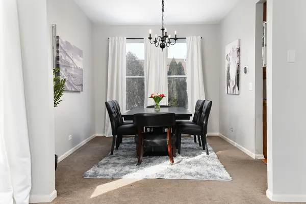 a view of a dining room with furniture and a potted plant