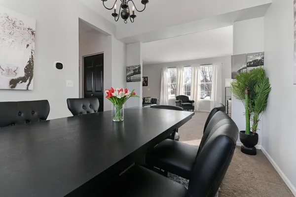 a dining room with furniture and wooden floor