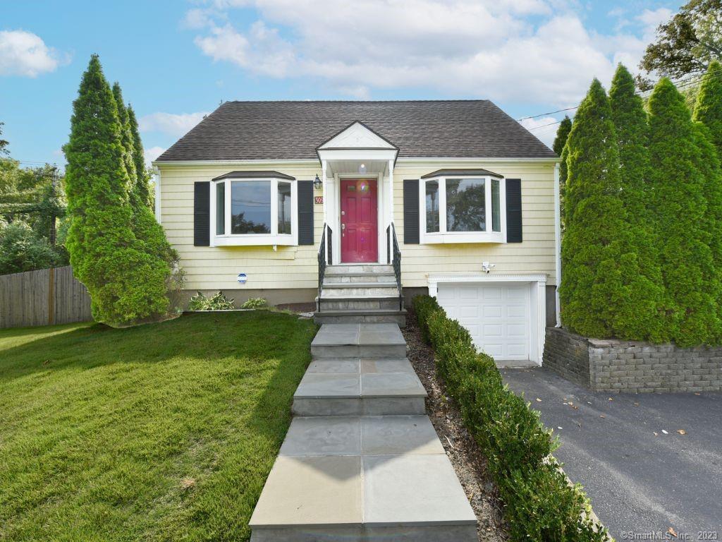 309 Round Hill Road Fairfield, CT 06824 - Photo 1 of 1 a front view of a house with garden