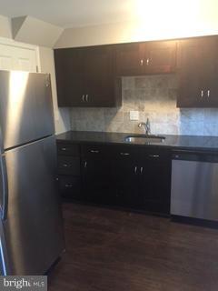 2065 Larkhall Road Baltimore, MD 21222 - Photo 2 of 6 a kitchen with a sink and cabinets