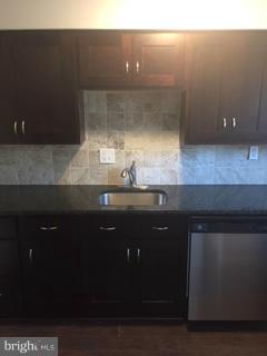 2065 Larkhall Road Baltimore, MD 21222 - Photo 4 of 6 a kitchen with a sink and cabinets