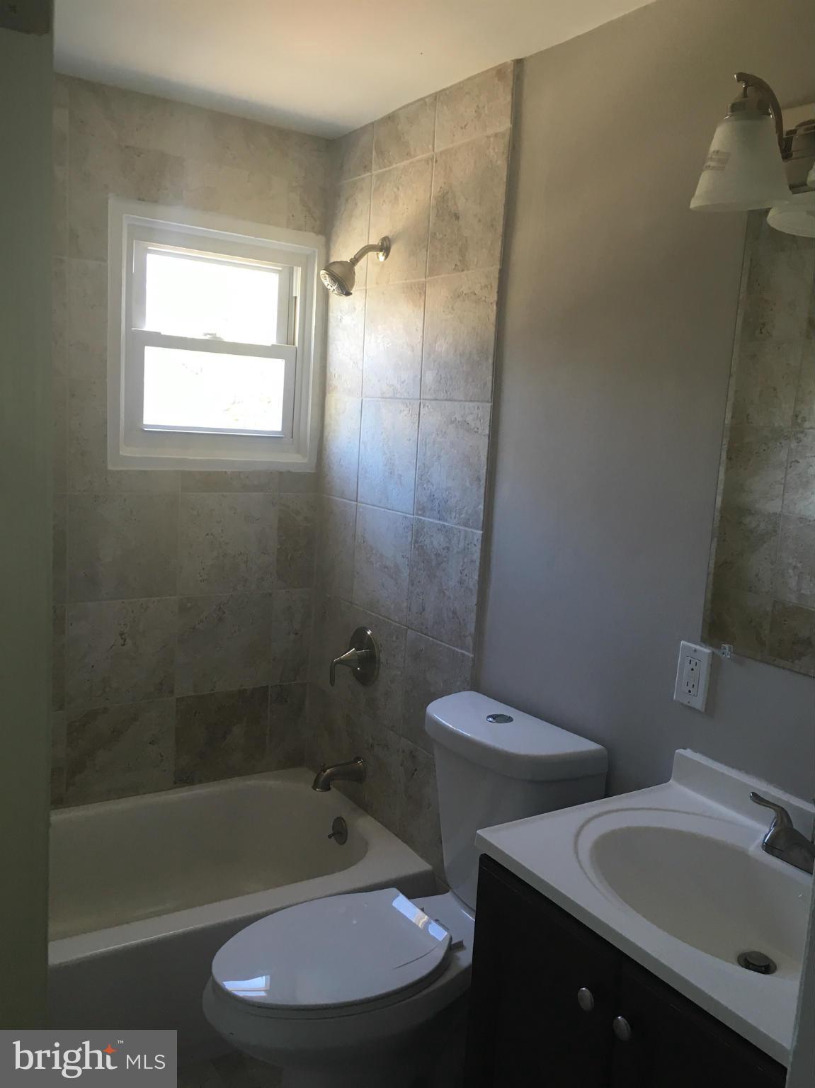 2065 Larkhall Road Baltimore, MD 21222 - Photo 5 of 6 a bathroom with a sink toilet and shower