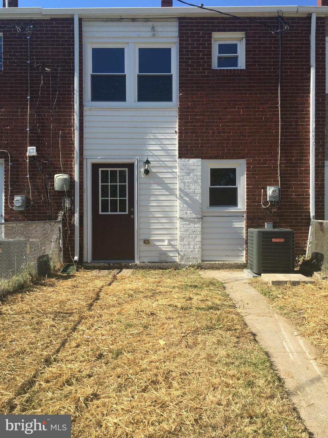2065 Larkhall Road Baltimore, MD 21222 - Photo 6 of 6 a view of yellow house with a yard