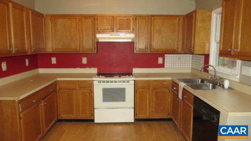 24 Colonial Road Palmyra, VA 22963 - Photo 3 of 17 a kitchen with a sink stove and cabinets
