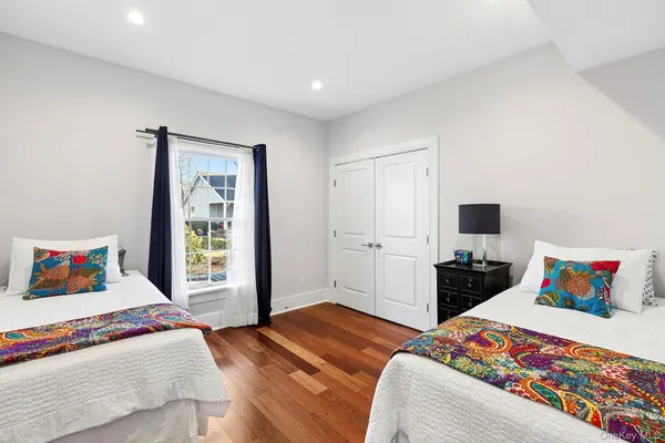 a living room with furniture a large window and stainless steel appliances