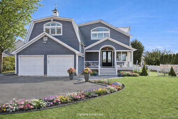 a dining room with stainless steel appliances kitchen island granite countertop a table chairs and a view of living room