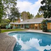 a front view of a house with a yard table and chairs