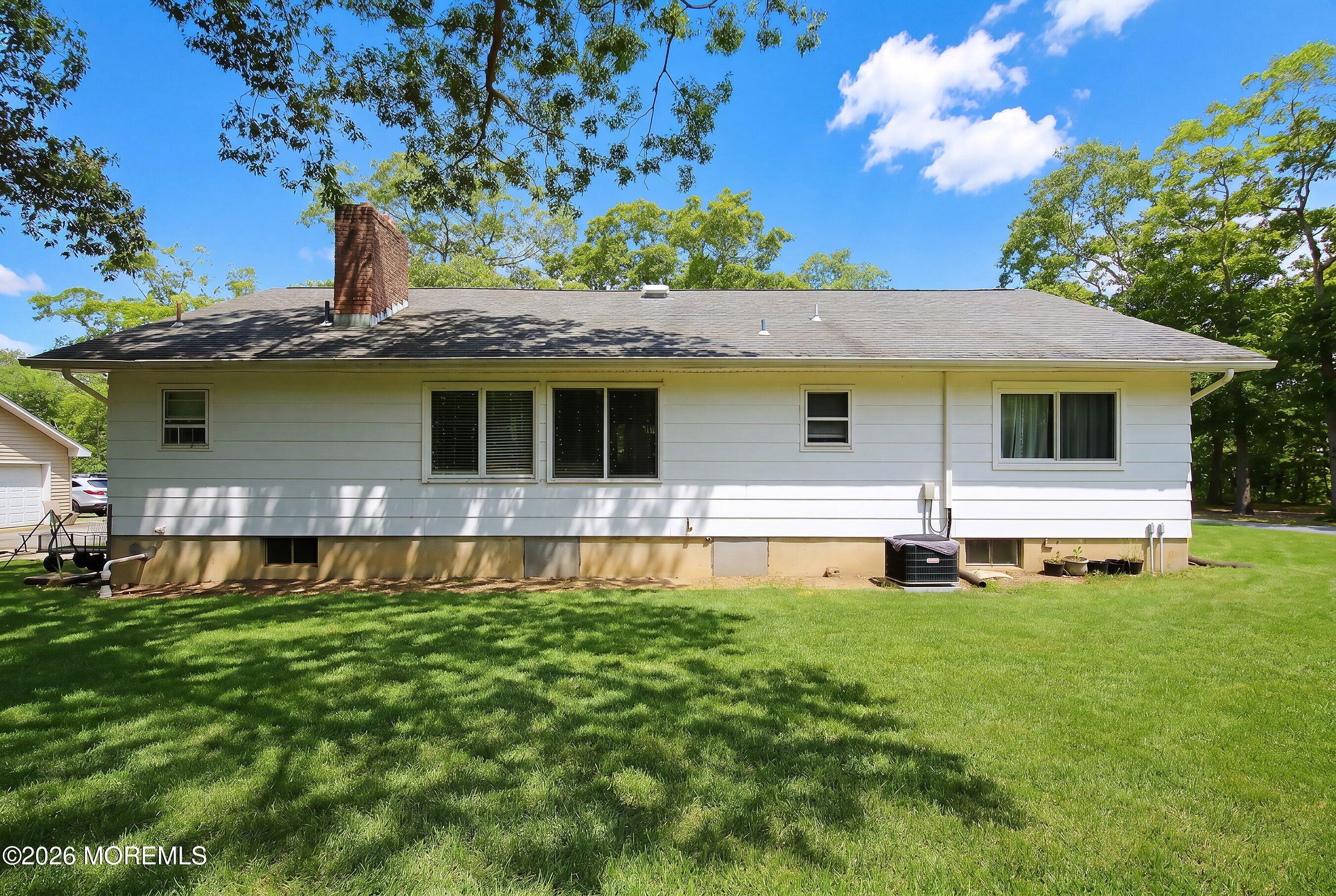 745 Oak Glen Road Howell, NJ 07731 - Photo 5 of 46 a front view of a house with a yard table and chairs