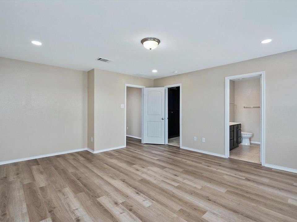 904 Lonesome Lilly Way Pflugerville, TX 78660 - Photo 18 of 34 The property features wood-style flooring, light-colored walls, and recessed lighting throughout the room