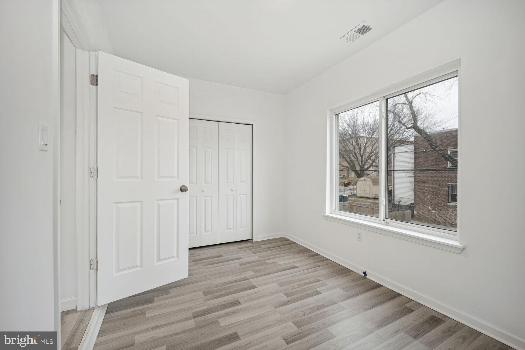 1642 16th Street Southeast, Unit 3 Washington, DC 20020 - Photo 16 of 22 an empty room with wooden floor and windows