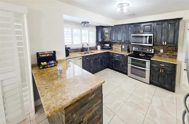 a kitchen with granite countertop a stove top oven and granite counter tops