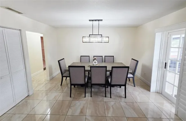 a view of a dining room with furniture and window