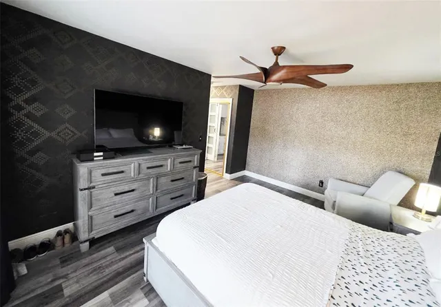 a bedroom with a bed and a flat screen tv