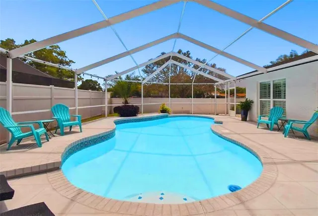 a view of a backyard with swimming pool