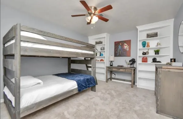 a bedroom with a bed and a desk