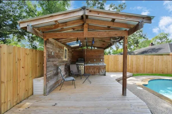 a patio with water glass top table and chairs
