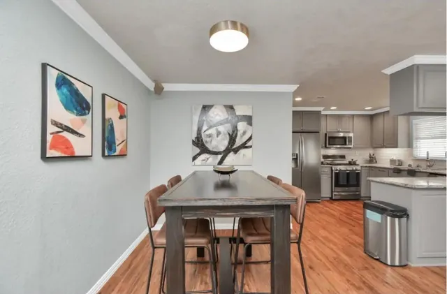 a kitchen with a table and chairs in it