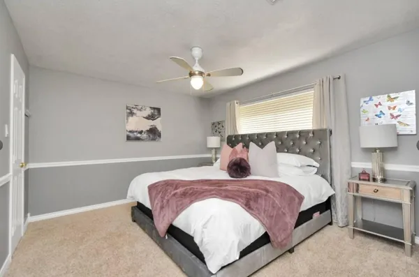 a bedroom with a bed and a chandelier