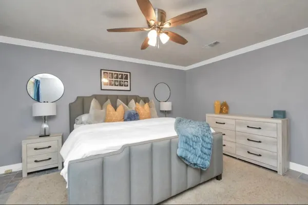 a bedroom with a bed and a chandelier