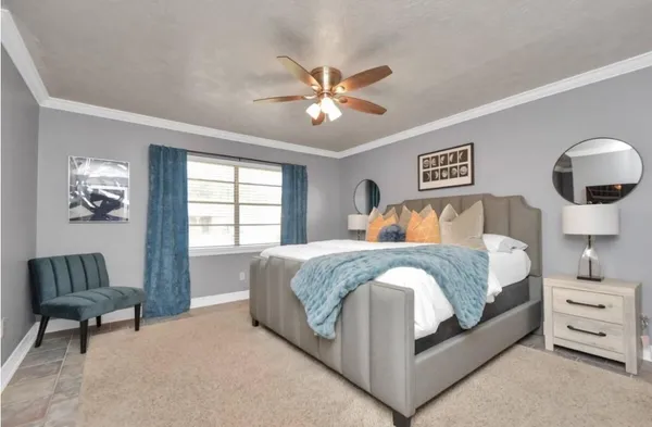 a bedroom with a bed and a chandelier