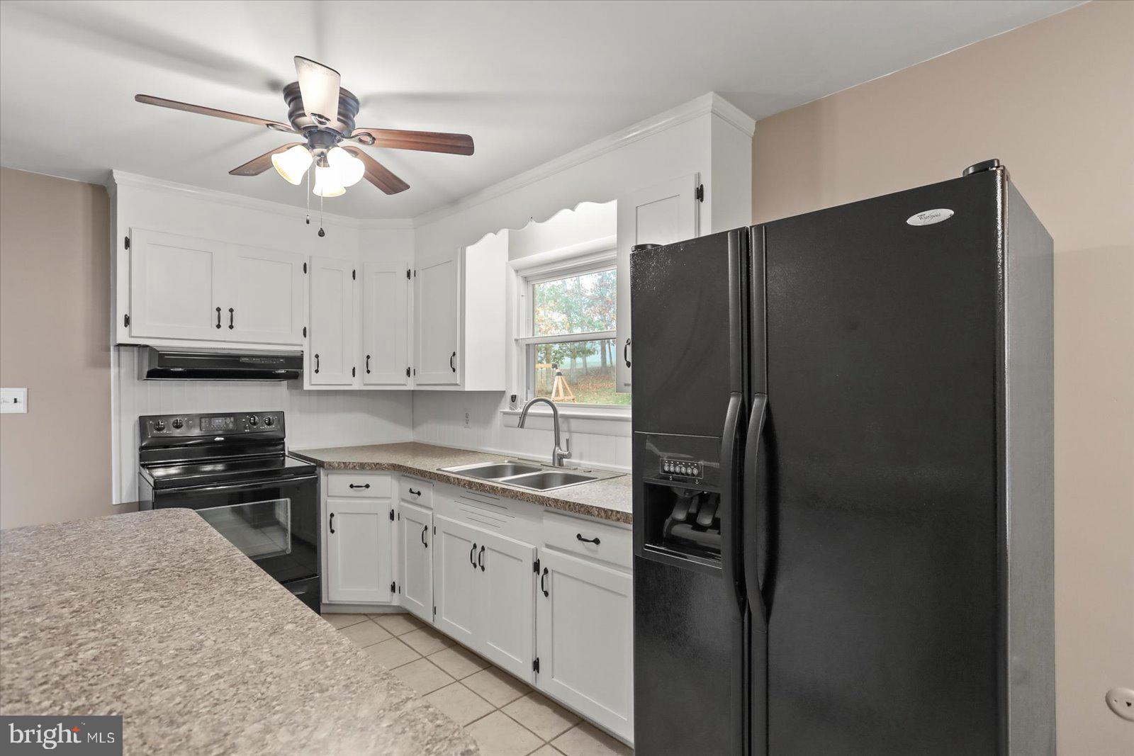 1384 Hunterstown Road Gettysburg, PA 17325 - Photo 12 of 37 a kitchen with stainless steel appliances granite countertop a refrigerator a stove a sink and cabinets