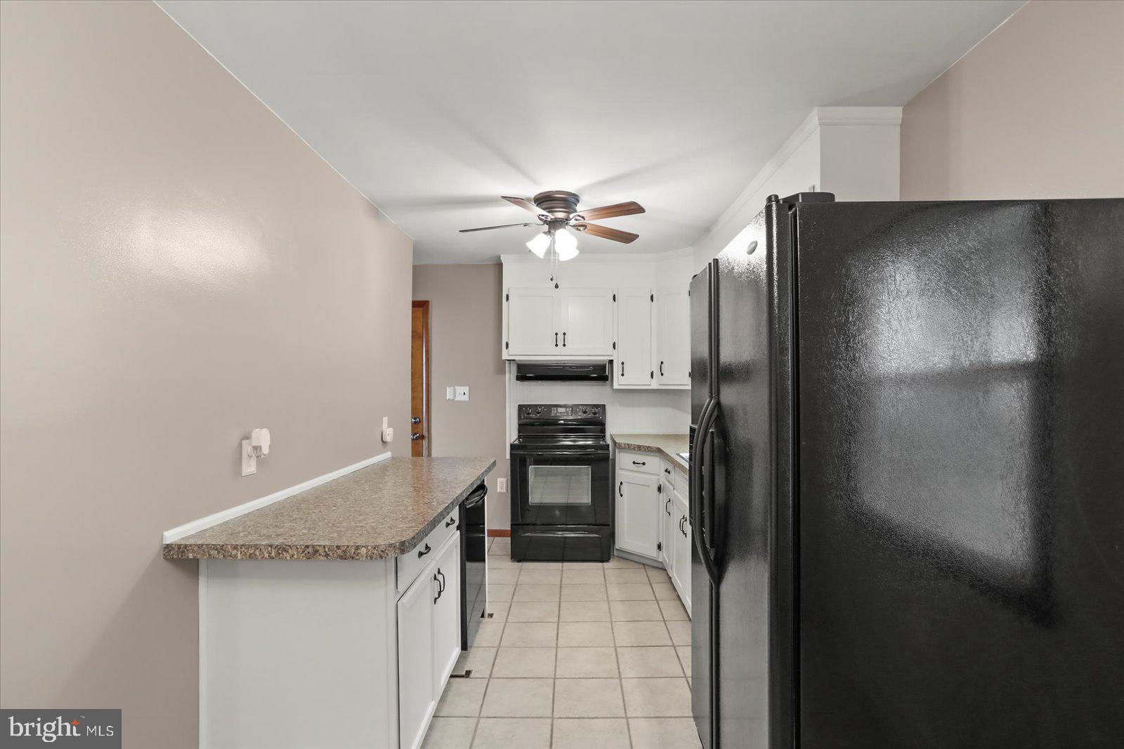 1384 Hunterstown Road Gettysburg, PA 17325 - Photo 13 of 37 a kitchen with stainless steel appliances a refrigerator and a stove