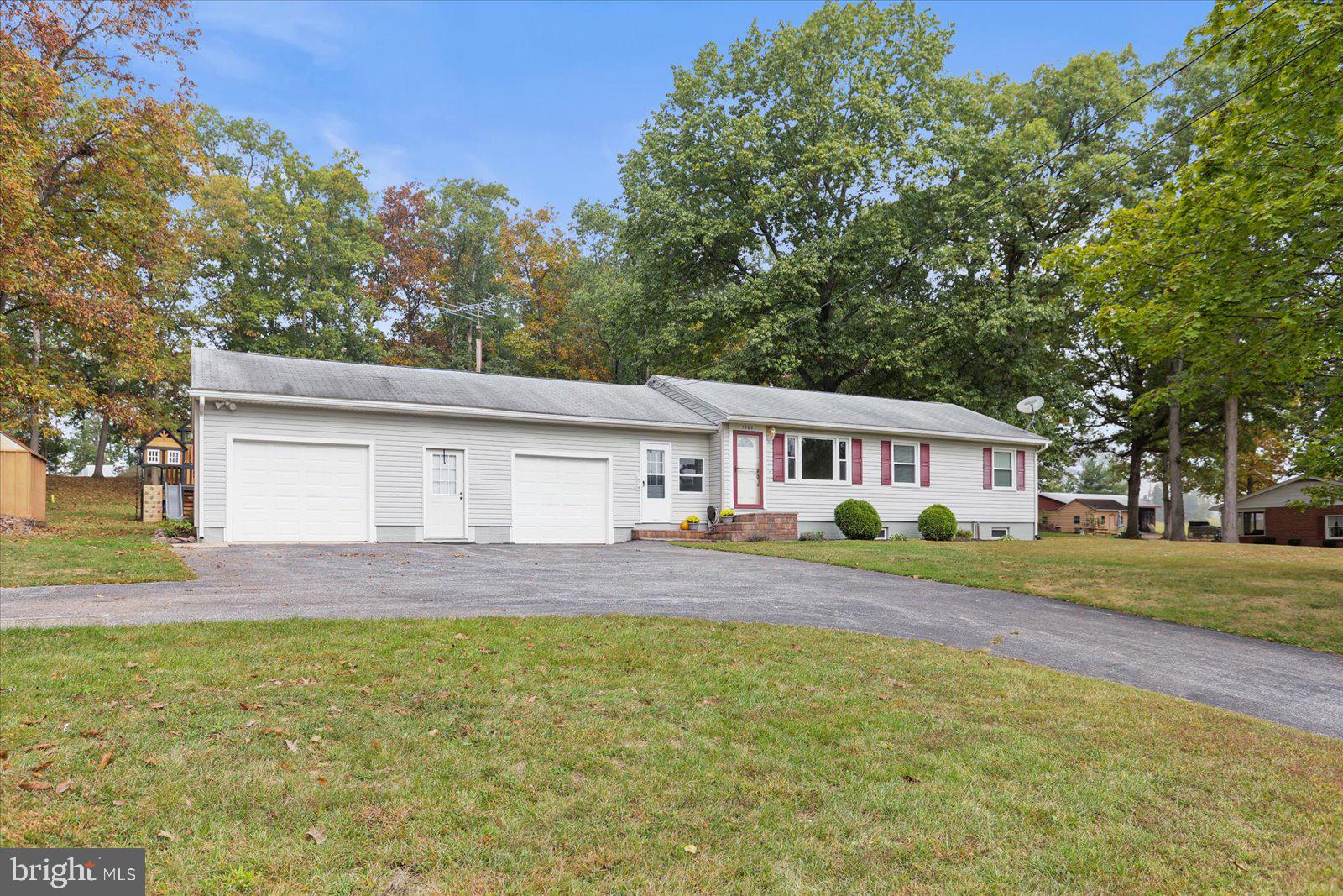 1384 Hunterstown Road Gettysburg, PA 17325 - Photo 3 of 37 a view of a yard in front of a house with a large tree