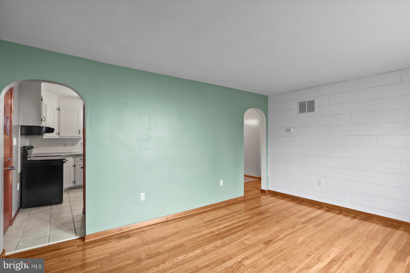 1384 Hunterstown Road Gettysburg, PA 17325 - Photo 9 of 37 an empty room with a fireplace and wooden floor