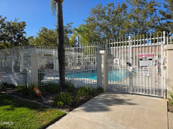 a view of a park with iron fence