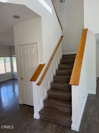 a view of entryway with wooden floor and stairs