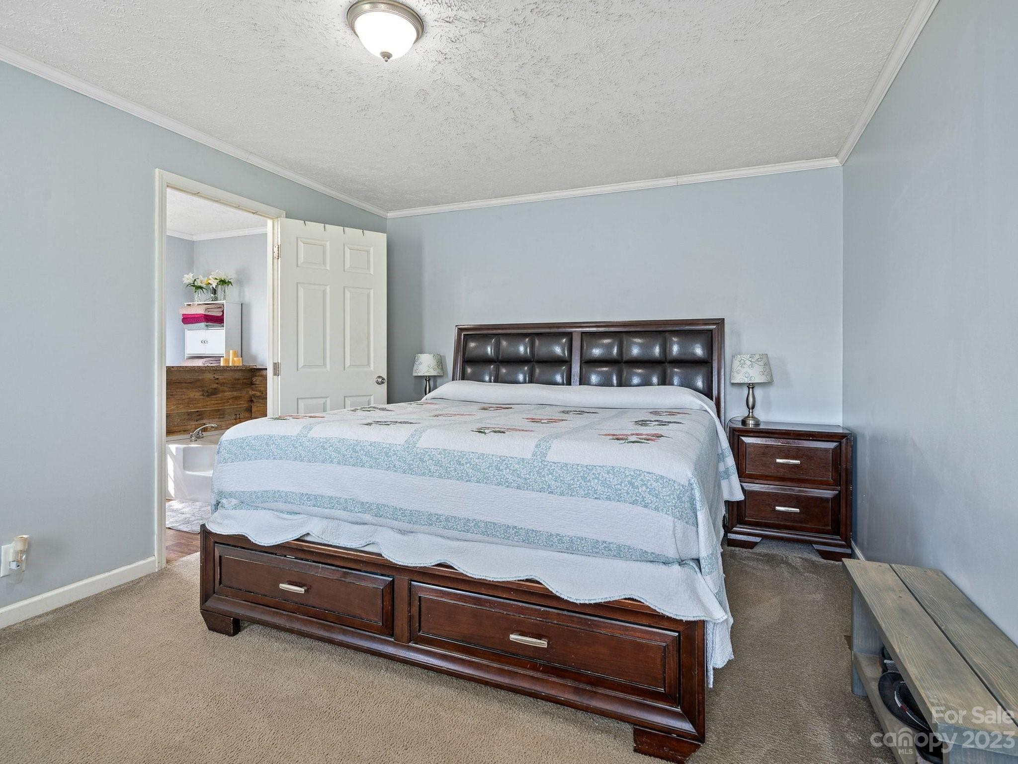 600 Sutton Spring Road York, SC 29745 - Photo 9 of 31 a bedroom with a bed and a chandelier