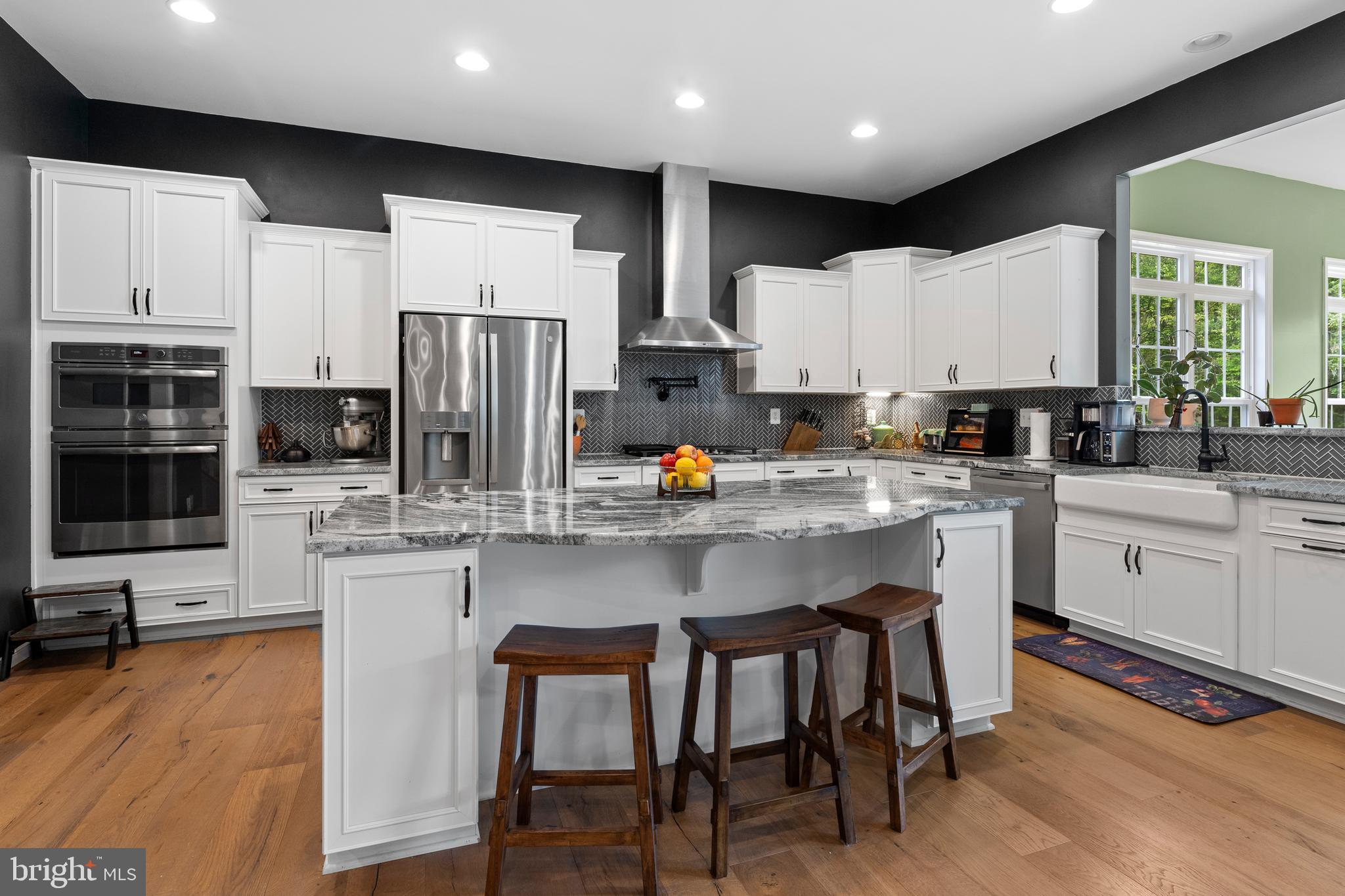 80 Shackelford Well Road Fredericksburg, VA 22406 - Photo 30 of 108 a kitchen with stainless steel appliances granite countertop a table chairs sink refrigerator and cabinets