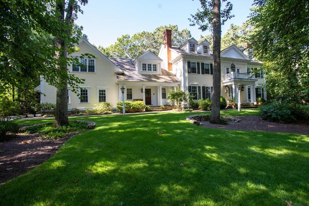 190 Winding River Road Wellesley, MA 02482 - Photo 1 of 18 a front view of a house with a garden and trees