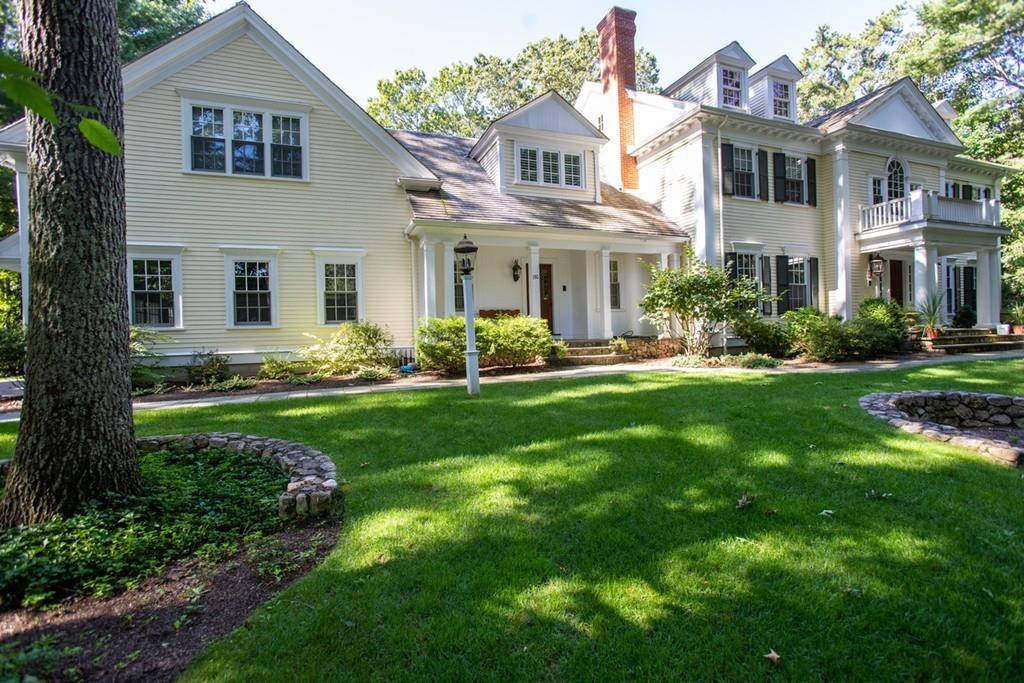 190 Winding River Road Wellesley, MA 02482 - Photo 2 of 18 a front view of a house with a garden and plants