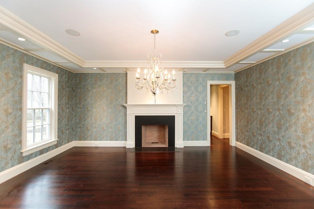 190 Winding River Road Wellesley, MA 02482 - Photo 5 of 18 a view of an empty room with wooden floor fireplace and a window