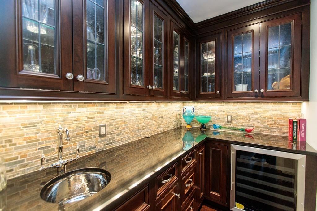 190 Winding River Road Wellesley, MA 02482 - Photo 7 of 18 a kitchen with a sink and a stove next to a window