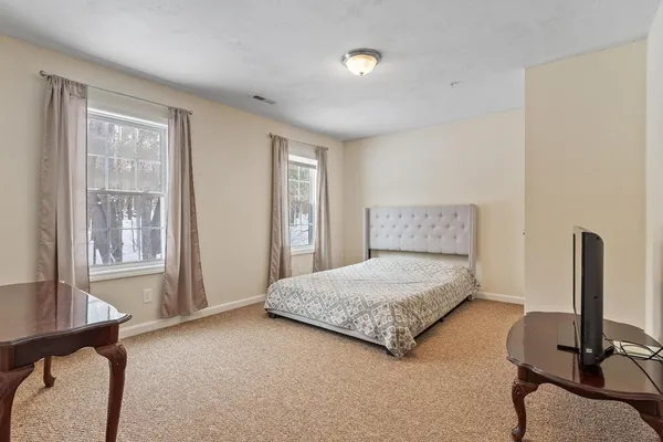 a bedroom with a bed and a desk