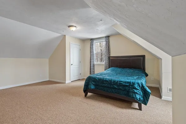 a bedroom with a bed and a cabinets