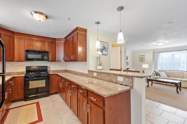 a kitchen with stainless steel appliances granite countertop a sink stove and microwave
