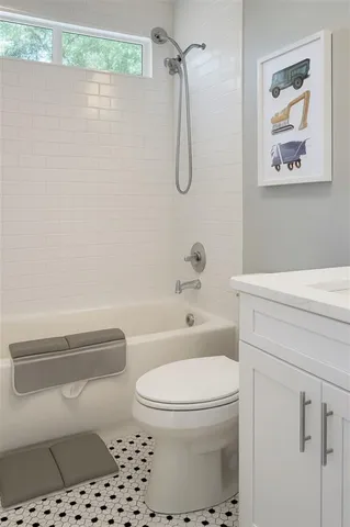 a bathroom with a toilet a sink and shower